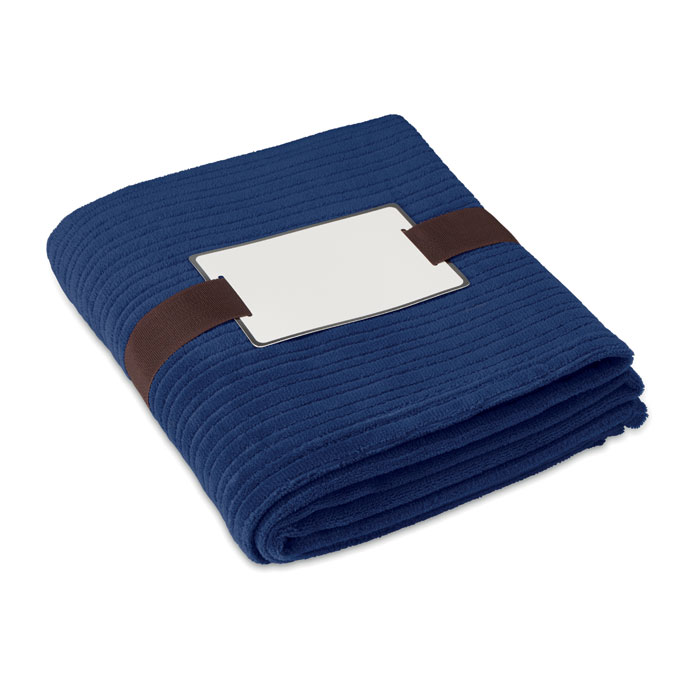 Coperta in pile morbido 240gr, confezionata con nastro e cartoncino stampabile — gadget promozionale personalizzabile con il tuo logo